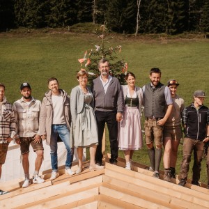 Stronger Together: The Reiter Family with the Construction Management and Carpentry Team on the Roof Truss